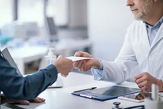 Doctor giving a certificate to his patient