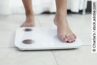 feet standing on electronic scales for weight control. Measureme