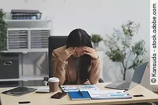 Portrait of tired young business Asian woman work with documents tax laptop computer in office. Sad, unhappy, Worried, Depression, or employee life stress concept Portrait of tired young business Asian woman work with documents tax laptop computer in office. Sad, unhappy, Worried, Depression, or employee life stress concept
