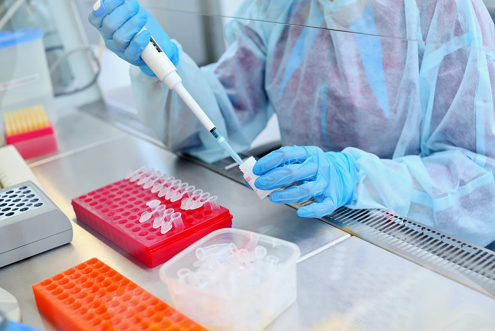 Dna test in the lab. a laboratory technician with a dispenser in Dna test in the lab. a laboratory technician with a dispenser in