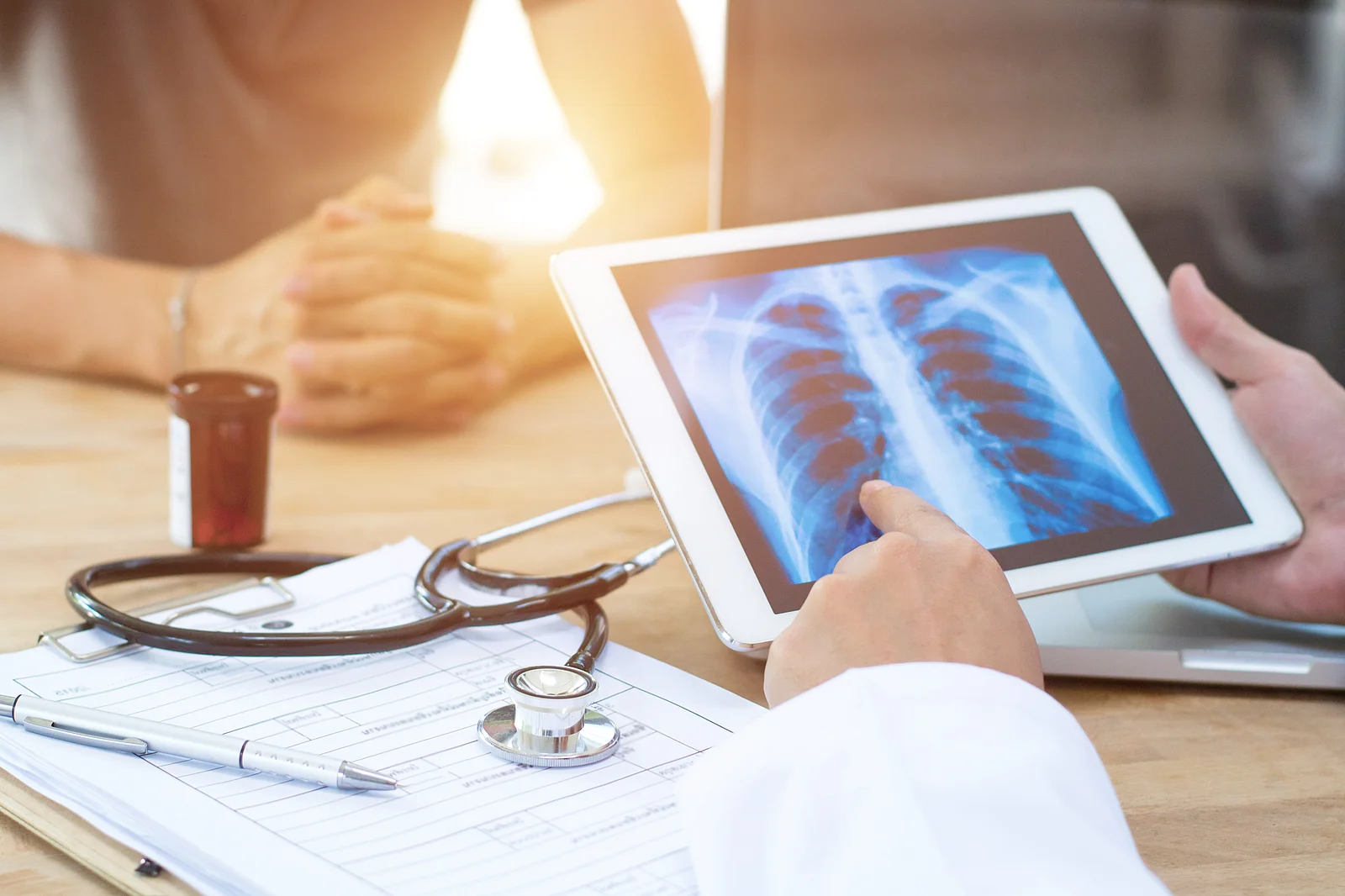 Doctor shows results to old patient x-ray of the lungs, smoking Doctor shows results to old patient x-ray of the lungs, smoking
